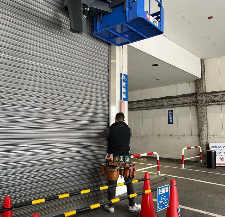 池田市内で電動シャッターを修理点検する代表の様子